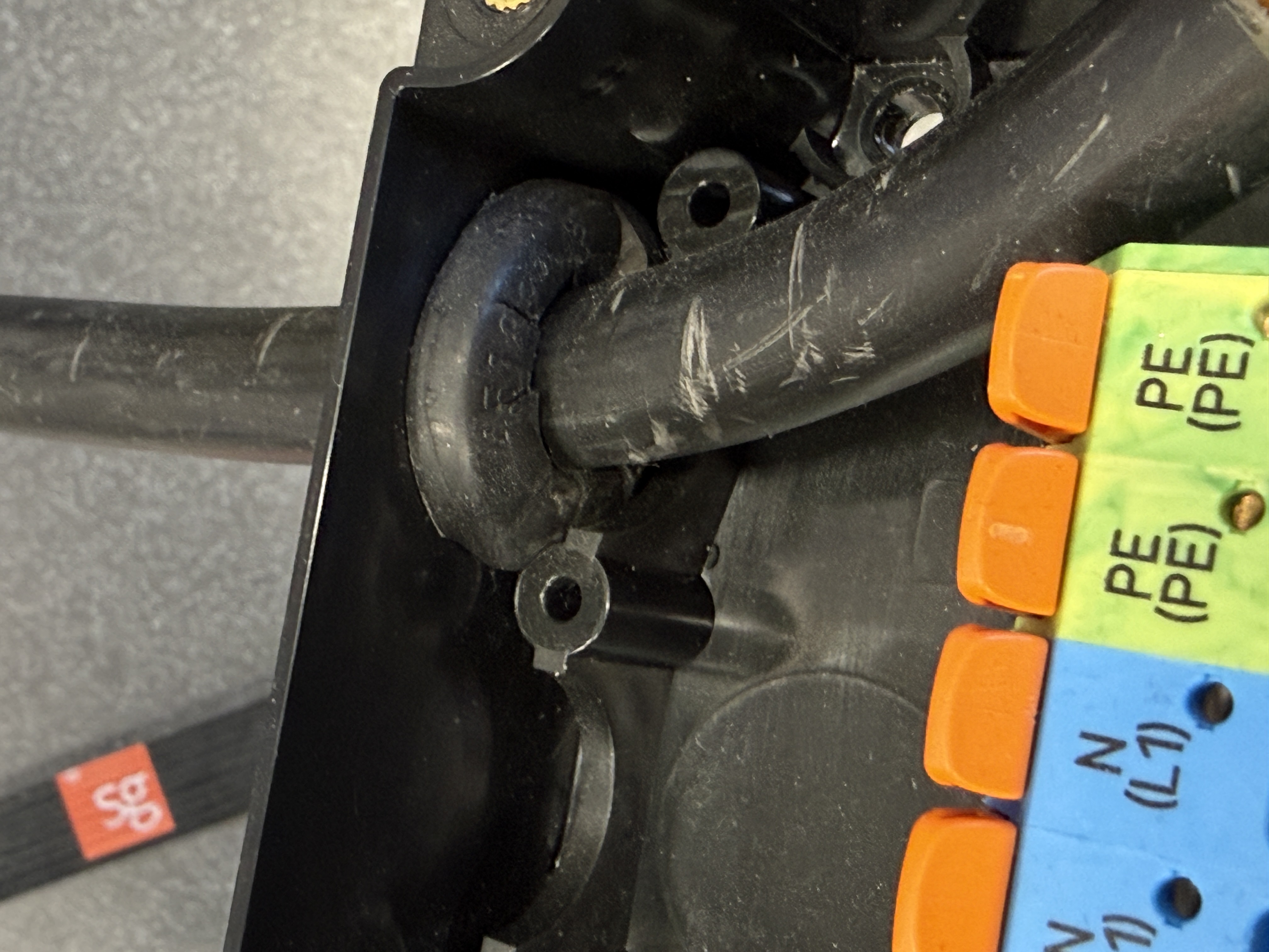 A grommet cut with a slit instead of a tight round hole, letting water in