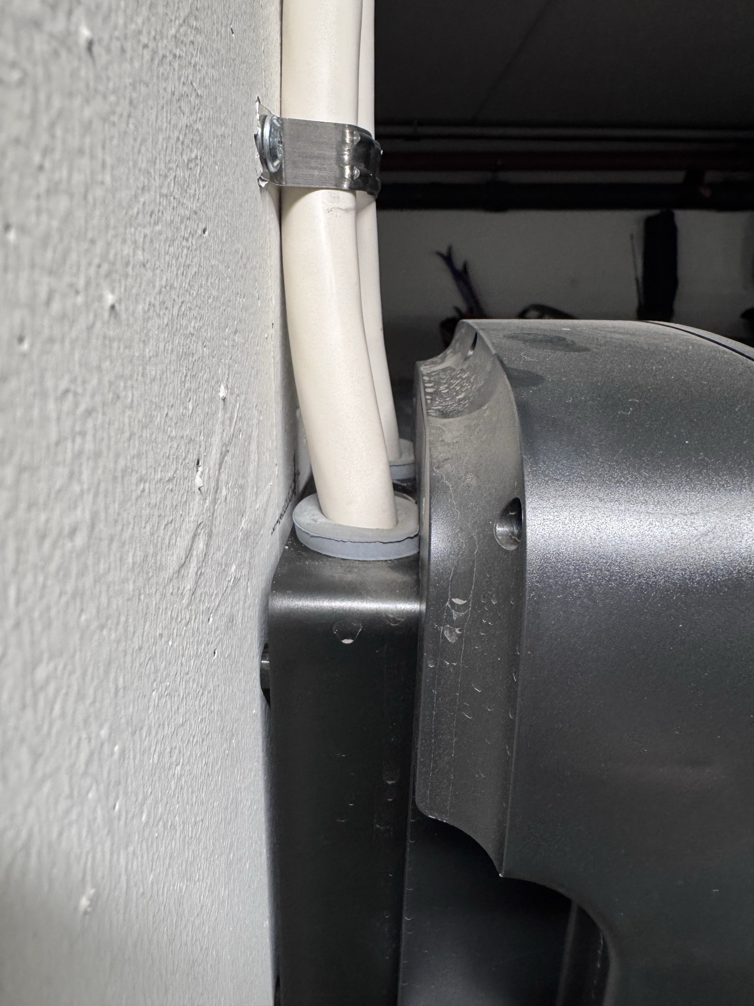 A non-original gasket protruding from the entry and pushing against the charger