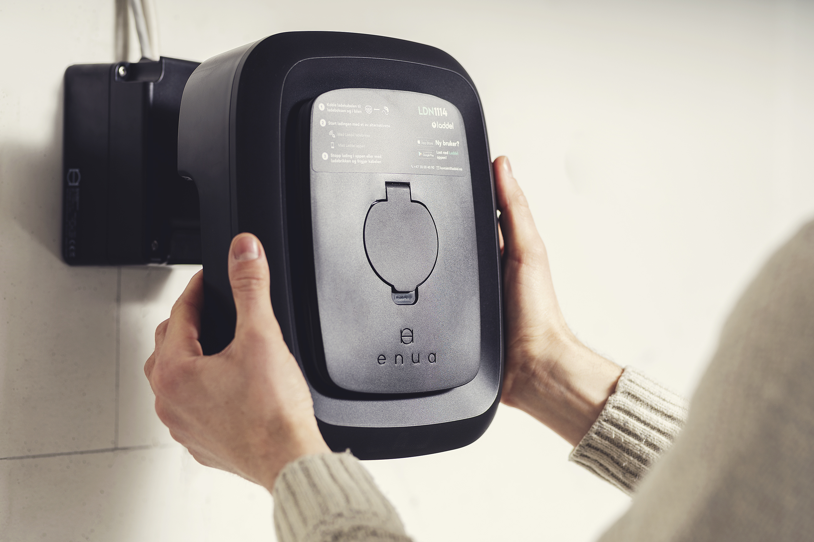 Pressing the Enua Charge straight onto its Wallmount with both hands